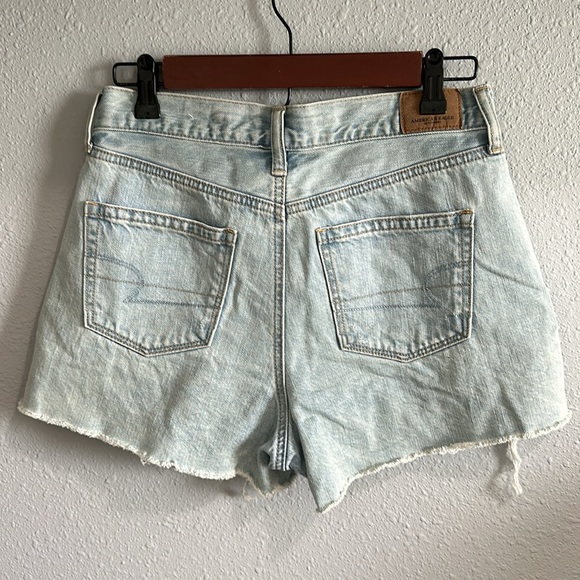 Light wash distressed denim shorts with lace detail. Size 4. - Picture 4 of 5